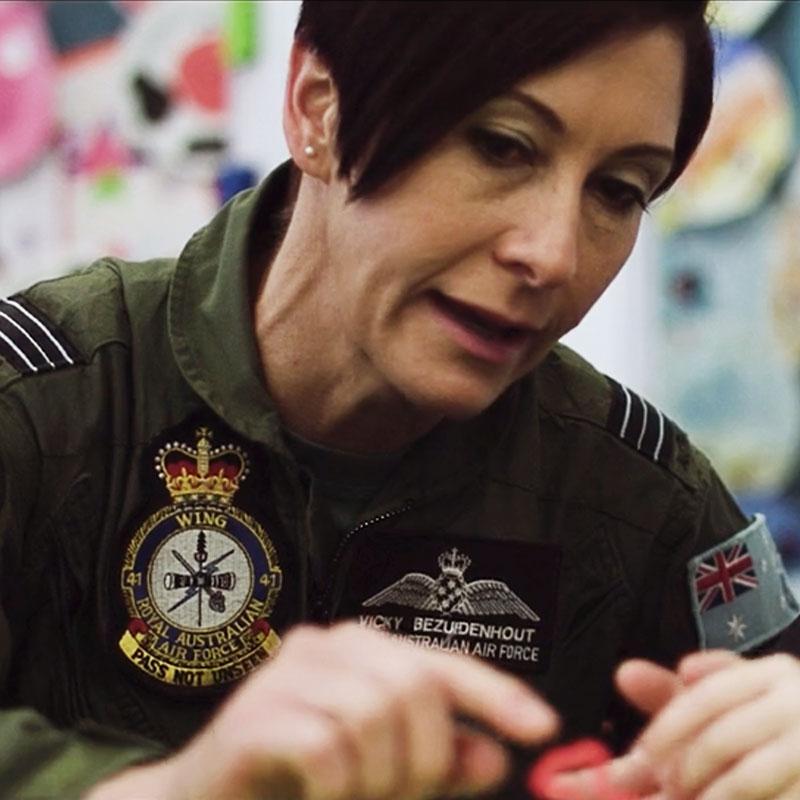 A Defence Force member engaging with a young student at Medowie Christian School as part of the Defence Support Program.