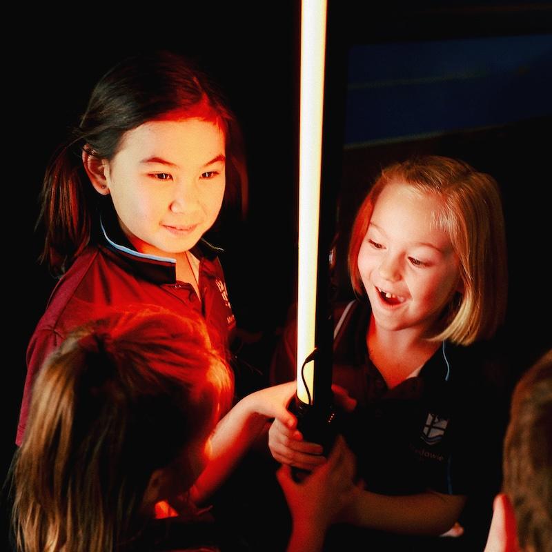 Young students at Medowie Christian School exploring a light experiment in an interactive learning approach.