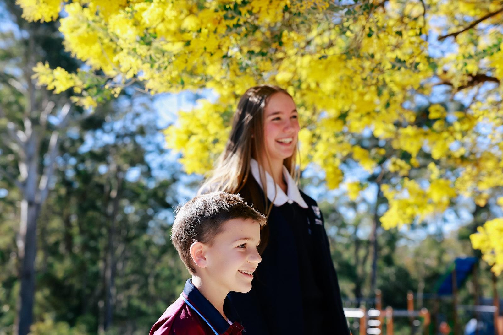 Primary and high school students in Port Stephens enjoying time outdoors under blooming wattle trees.