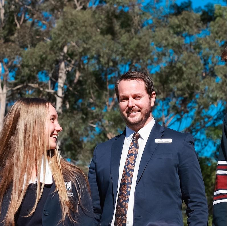 Medowie School Pricipal Dan Weeks walking and talking with school captains under tall eucalyptus trees