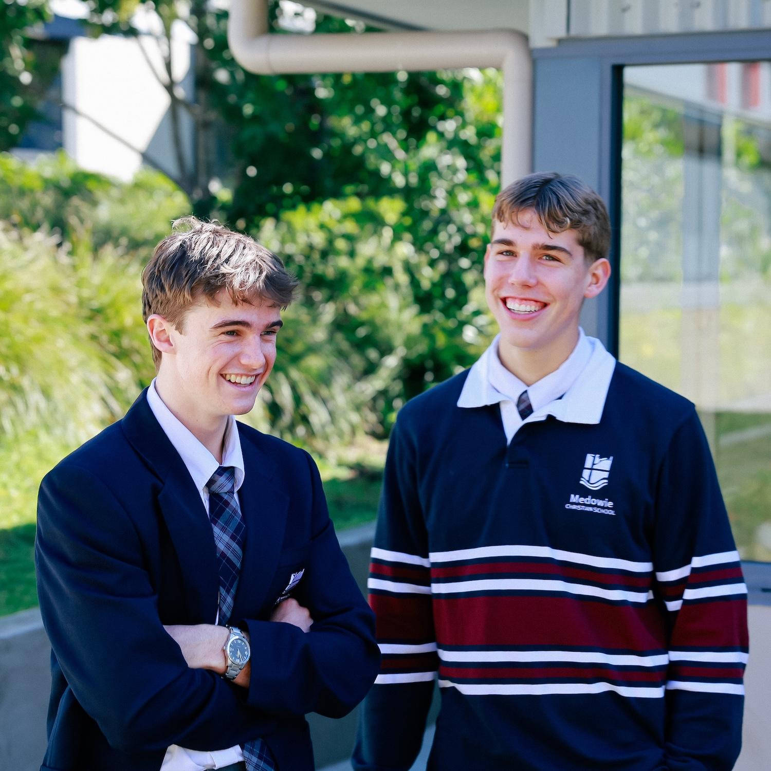 Senior school student captains sharing a moment of camaraderie outdoors at Medowie Christian School.